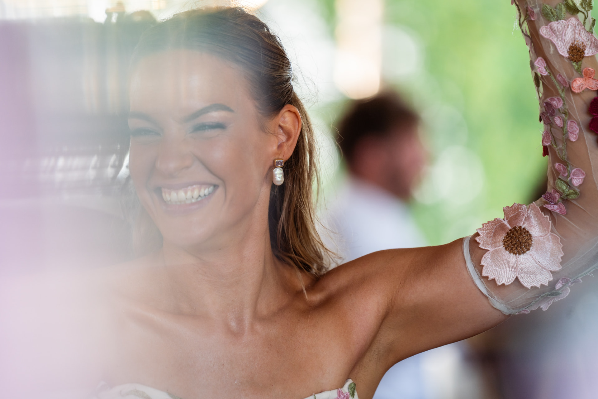Bride holding a bouquet by a window